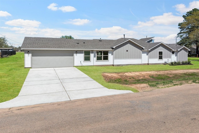 2845 14th St, Hempstead, TX 77445 - view of front facade with board and batten siding, concrete driveway, an attached garage, and a front lawn