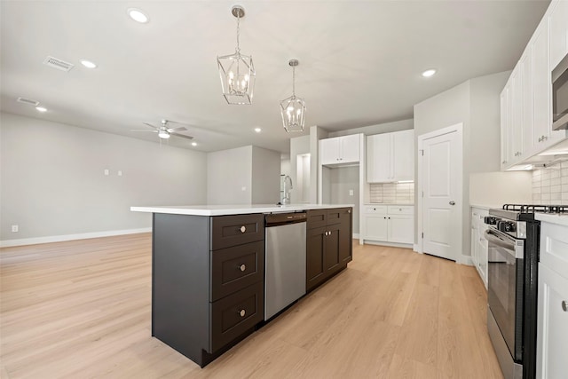 2845 14th St, Hempstead, TX 77445 - kitchen featuring dishwasher, gas range oven, ceiling fan, white cabinetry, and light wood-type flooring