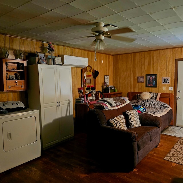 710 College St, El Campo, TX 77437 - living room featuring washer / dryer, a ceiling fan, wooden walls, and wood finished floors