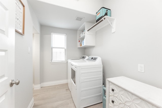 13746 Brahman Valley Ct, Cypress, TX 77429 - laundry area with washing machine and dryer and light wood-style flooring