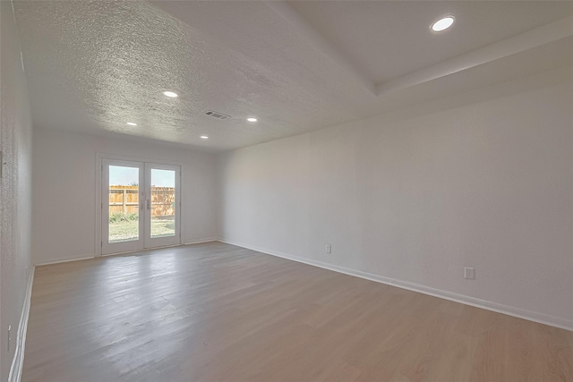 6219 Canada Dr, Pasadena, TX 77505 - spare room with wood finished floors, a textured ceiling, and recessed lighting