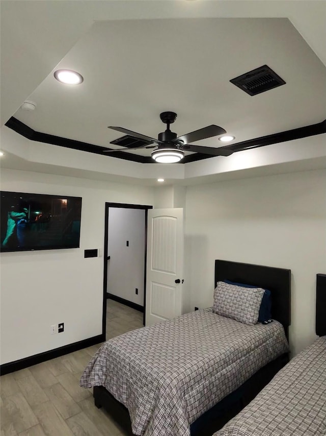 4739 Reed Rd Unit A, Houston, TX 77033 - bedroom with light wood-style flooring, recessed lighting, a ceiling fan, and a raised ceiling