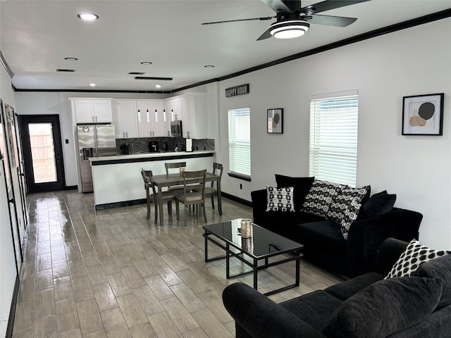 4739 Reed Rd Unit A, Houston, TX 77033 - living area with crown molding, ceiling fan, light wood finished floors, and recessed lighting