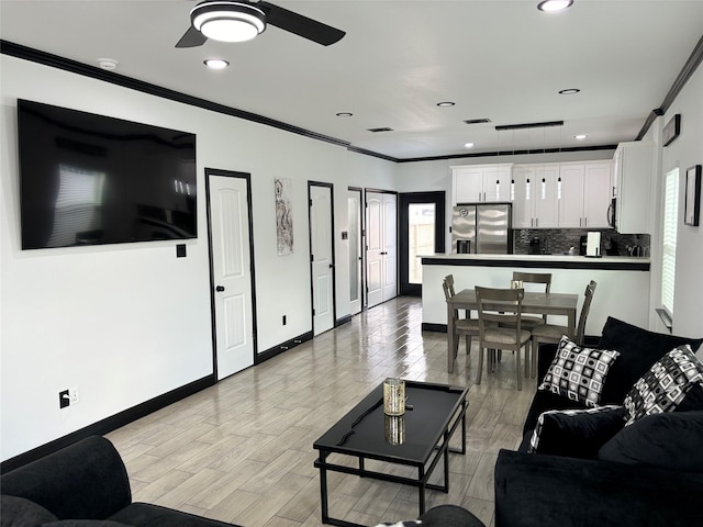 4739 Reed Rd Unit A, Houston, TX 77033 - living area with crown molding, ceiling fan, light wood finished floors, and recessed lighting