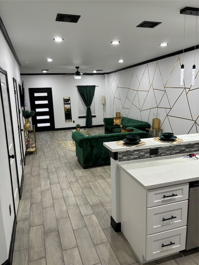 4739 Reed Rd Unit A, Houston, TX 77033 - kitchen featuring white cabinetry, tasteful backsplash, light wood-style floors, decorative light fixtures, and a ceiling fan
