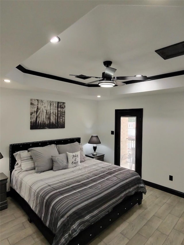 4739 Reed Rd Unit A, Houston, TX 77033 - bedroom featuring light wood-style floors, recessed lighting, a ceiling fan, and a raised ceiling