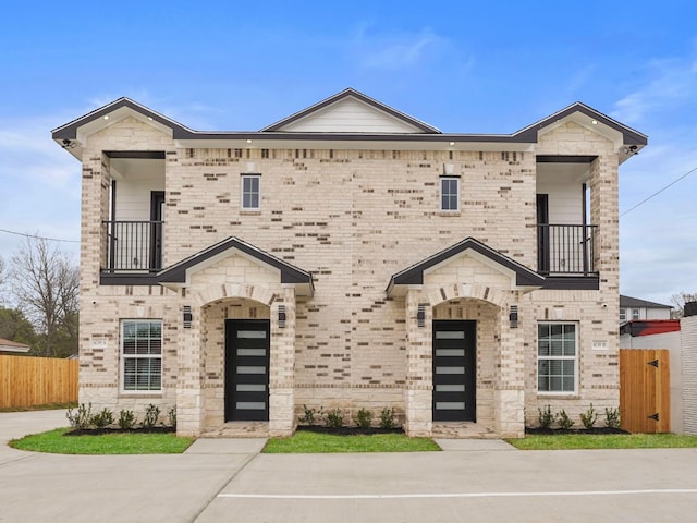 4739 Reed Rd Unit A, Houston, TX 77033 - view of front facade featuring a balcony and brick siding