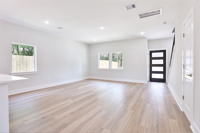 6909 S Hall St, Houston, TX 77028 - unfurnished living room with light wood finished floors and recessed lighting