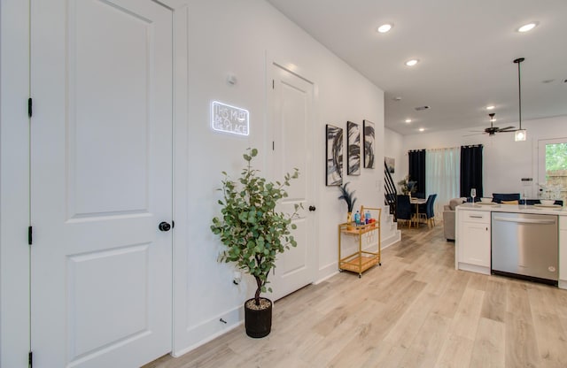 1616 Benson St, Houston, TX 77020 - kitchen with stainless steel dishwasher, light wood-style floors, white cabinets, recessed lighting, and ceiling fan