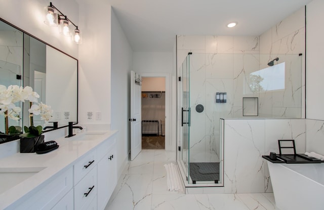 1616 Benson St, Houston, TX 77020 - bathroom featuring marble tiled floors, a marble finish shower, double vanity, a soaking tub, and recessed lighting
