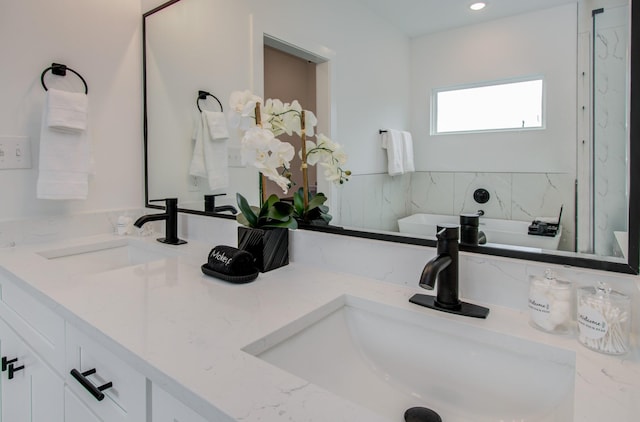1616 Benson St, Houston, TX 77020 - full bath with double vanity, a tub, and recessed lighting