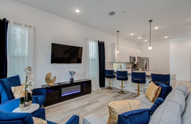 1616 Benson St, Houston, TX 77020 - living area featuring light wood-style flooring and recessed lighting