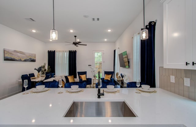 1616 Benson St, Houston, TX 77020 - kitchen with open floor plan, pendant lighting, ceiling fan, white cabinetry, and recessed lighting