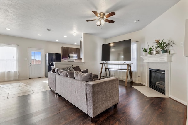20507 Avery Grove Ct, Cypress, TX 77433 - living area with a ceiling fan, a fireplace, wood finished floors, and recessed lighting