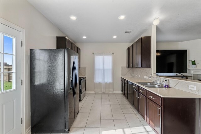 20507 Avery Grove Ct, Cypress, TX 77433 - kitchen featuring black fridge with ice dispenser, dark brown cabinetry, light countertops, backsplash, and recessed lighting