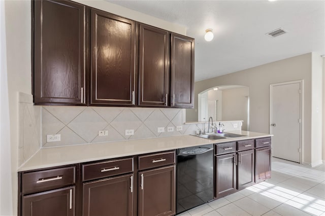 20507 Avery Grove Ct, Cypress, TX 77433 - kitchen with black dishwasher, arched walkways, tasteful backsplash, and light countertops