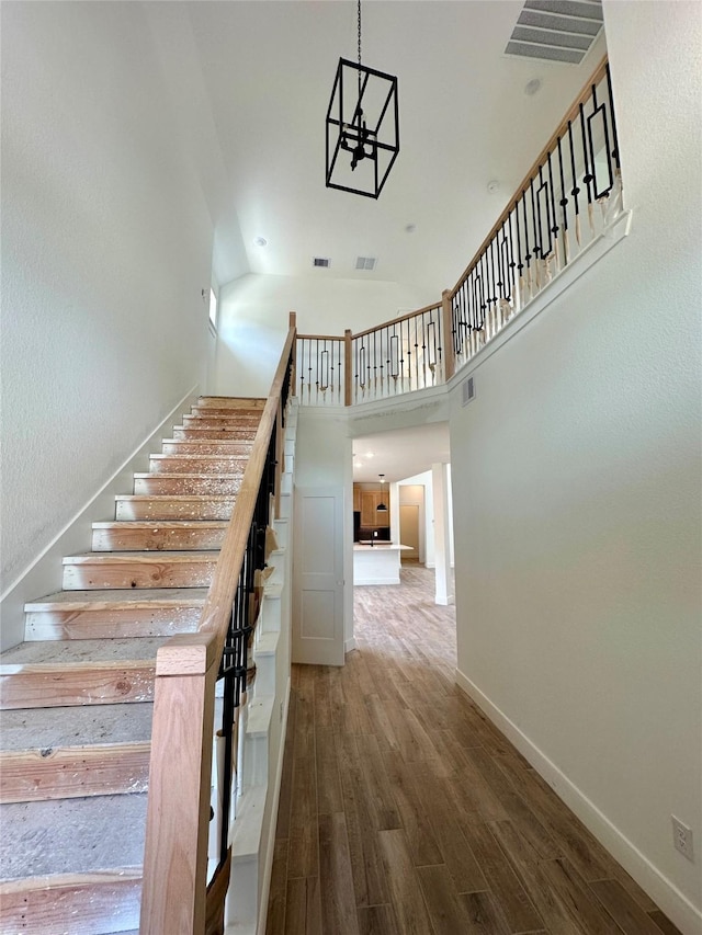 16446 Elk Meadow Dr, Conroe, TX 77302 - staircase with wood finished floors and high vaulted ceiling