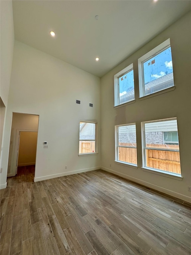 16446 Elk Meadow Dr, Conroe, TX 77302 - spare room with a high ceiling, wood finished floors, and recessed lighting