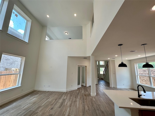 16446 Elk Meadow Dr, Conroe, TX 77302 - unfurnished living room featuring wood finished floors, stairway, a high ceiling, and recessed lighting