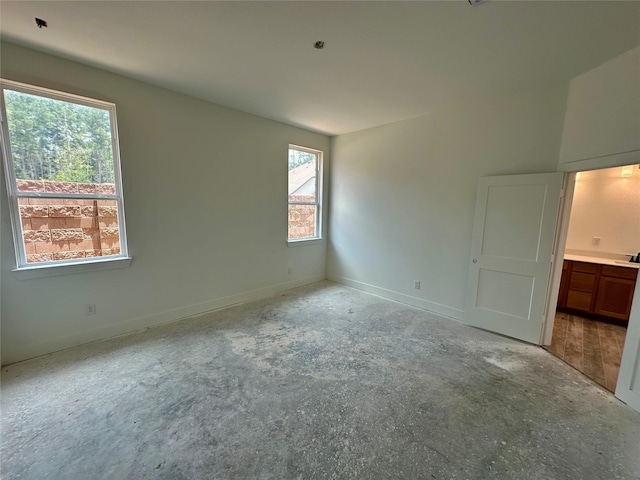 16446 Elk Meadow Dr, Conroe, TX 77302 - unfurnished bedroom featuring baseboards and unfinished concrete floors