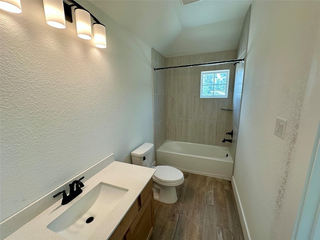 16446 Elk Meadow Dr, Conroe, TX 77302 - full bathroom with vanity, wood finished floors, a textured wall, shower / bath combination, and vaulted ceiling