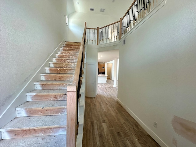 16446 Elk Meadow Dr, Conroe, TX 77302 - stairway featuring a towering ceiling and wood finished floors