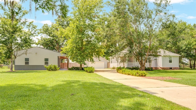 238 Horse Shoe Trl, Angleton, TX 77515 - view of front of house with an outbuilding, concrete driveway, and a front lawn