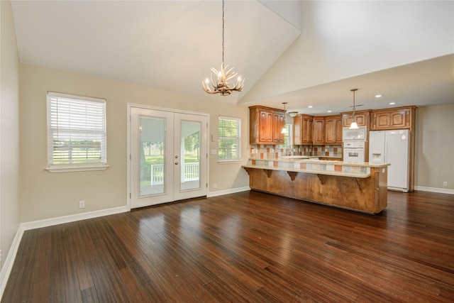 238 Horse Shoe Trl, Angleton, TX 77515 - kitchen featuring white appliances, light countertops, a peninsula, french doors, and dark wood-style floors