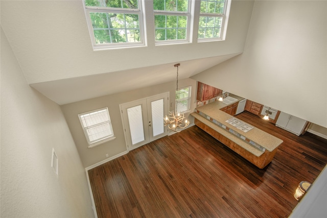 238 Horse Shoe Trl, Angleton, TX 77515 - living room featuring a high ceiling, a chandelier, and dark wood finished floors