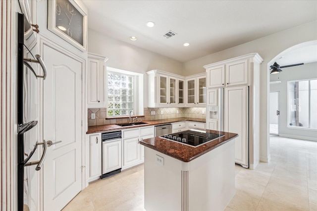 966 Bentwater Dr, Montgomery, TX 77356 - kitchen with black electric cooktop, paneled fridge, stainless steel dishwasher, fridge, and backsplash