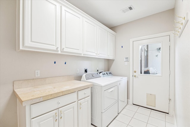 966 Bentwater Dr, Montgomery, TX 77356 - washroom featuring cabinet space, washer and dryer, and light tile patterned floors