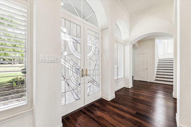 966 Bentwater Dr, Montgomery, TX 77356 - foyer with ornamental molding, arched walkways, dark wood-type flooring, stairway, and french doors