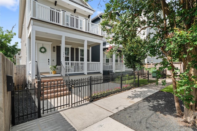 344 W 27th St, Houston, TX 77008 - view of front of house featuring a porch, a balcony, a fenced front yard, and a gate