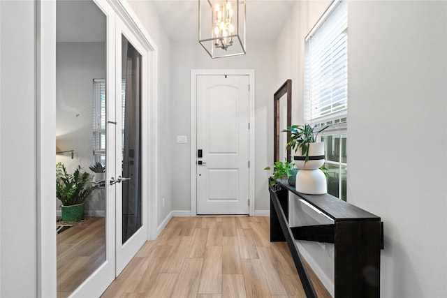 344 W 27th St, Houston, TX 77008 - foyer entrance with light wood-style floors, a chandelier, and french doors