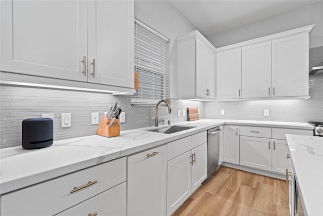 344 W 27th St, Houston, TX 77008 - kitchen featuring white cabinetry, dishwasher, backsplash, light wood finished floors, and light stone counters