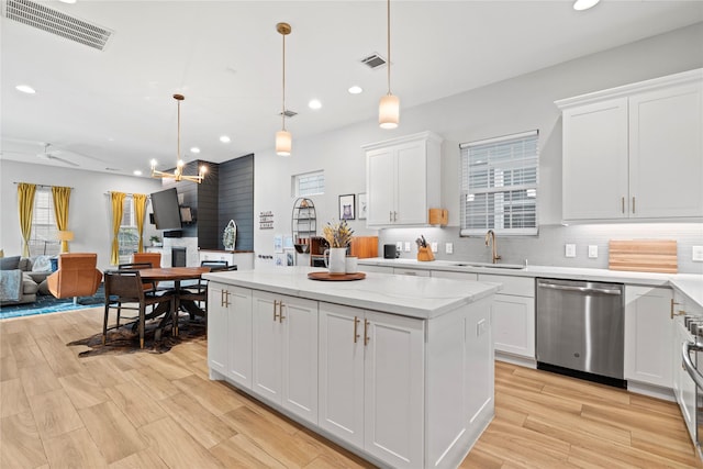 344 W 27th St, Houston, TX 77008 - kitchen with stainless steel dishwasher, open floor plan, a center island, decorative backsplash, and recessed lighting
