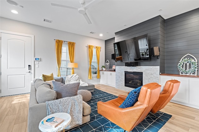 344 W 27th St, Houston, TX 77008 - living area with wood finished floors, ceiling fan, recessed lighting, a glass covered fireplace, and wooden walls