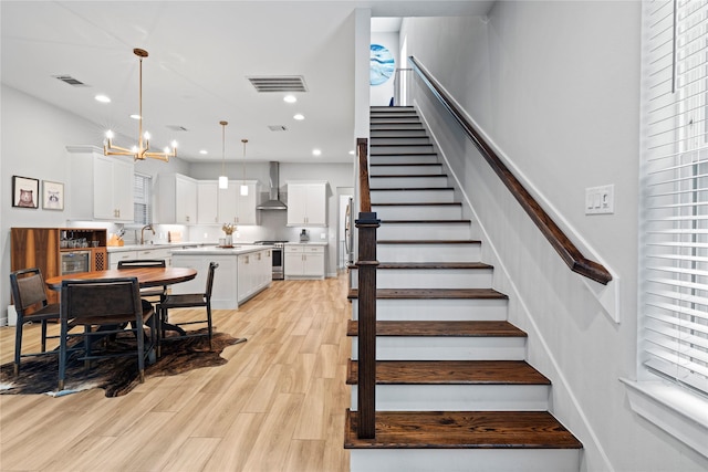 344 W 27th St, Houston, TX 77008 - stairs with a chandelier, wood finished floors, and recessed lighting