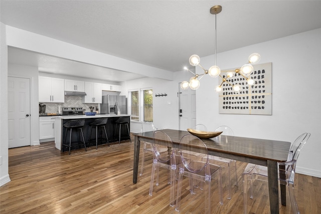 3404 Rosedale St, Houston, TX 77004 - dining room featuring wood finished floors and a chandelier