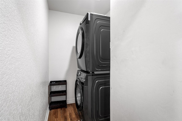 3404 Rosedale St, Houston, TX 77004 - laundry room featuring stacked washer / drying machine, dark wood finished floors, and a textured wall