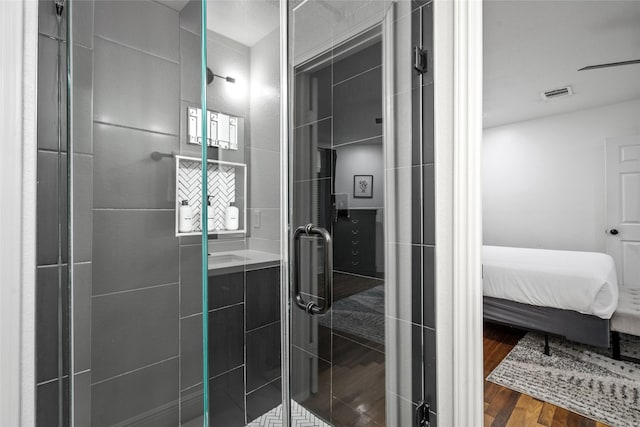 3404 Rosedale St, Houston, TX 77004 - full bathroom featuring wood finished floors, a stall shower, and ensuite bath