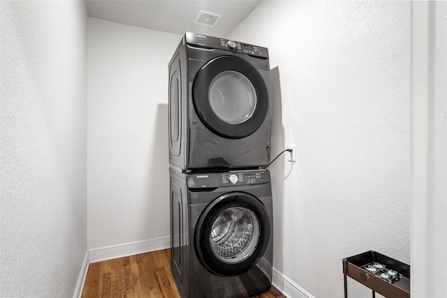 3404 Rosedale St, Houston, TX 77004 - laundry room with stacked washer / drying machine and wood finished floors