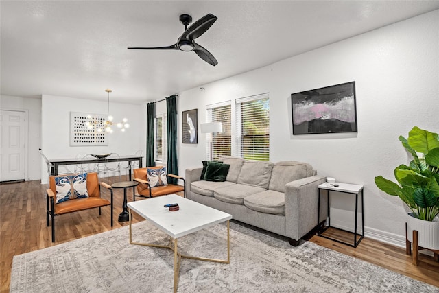 3404 Rosedale St, Houston, TX 77004 - living room featuring wood finished floors, a chandelier, and a ceiling fan