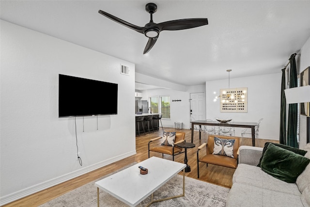3404 Rosedale St, Houston, TX 77004 - living area featuring wood finished floors, a chandelier, and a ceiling fan