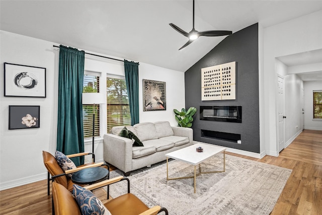 3404 Rosedale St, Houston, TX 77004 - living area with lofted ceiling, ceiling fan, wood finished floors, and a glass covered fireplace