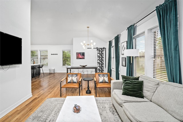 3404 Rosedale St, Houston, TX 77004 - living area with a chandelier, vaulted ceiling, plenty of natural light, and wood finished floors