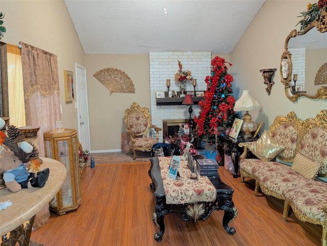7140 S Dairy Ashford Rd, Houston, TX 77072 - living room with vaulted ceiling, wood finished floors, a textured ceiling, and a fireplace