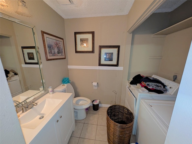 7140 S Dairy Ashford Rd, Houston, TX 77072 - bathroom featuring independent washer and dryer, vanity, a textured ceiling, and tile patterned floors