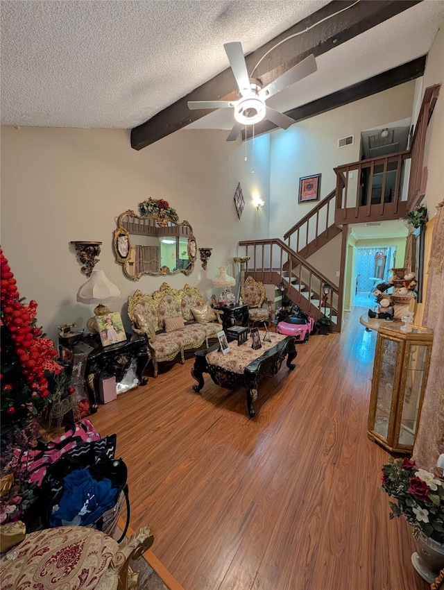 7140 S Dairy Ashford Rd, Houston, TX 77072 - living room featuring wood finished floors, stairway, a ceiling fan, and a textured ceiling