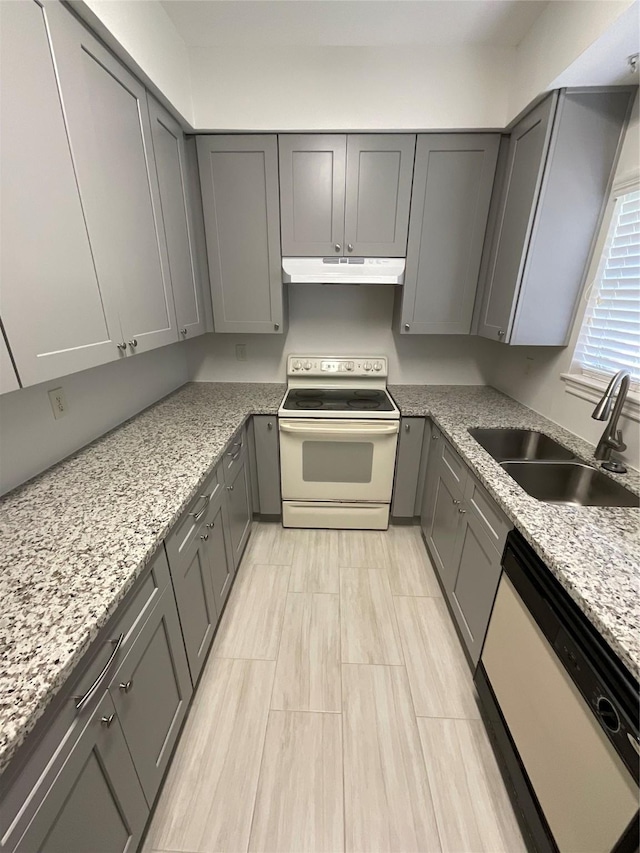 3100 Walnut Bend Ln Unit 113, Houston, TX 77042 - kitchen with white appliances, gray cabinetry, under cabinet range hood, and light stone countertops